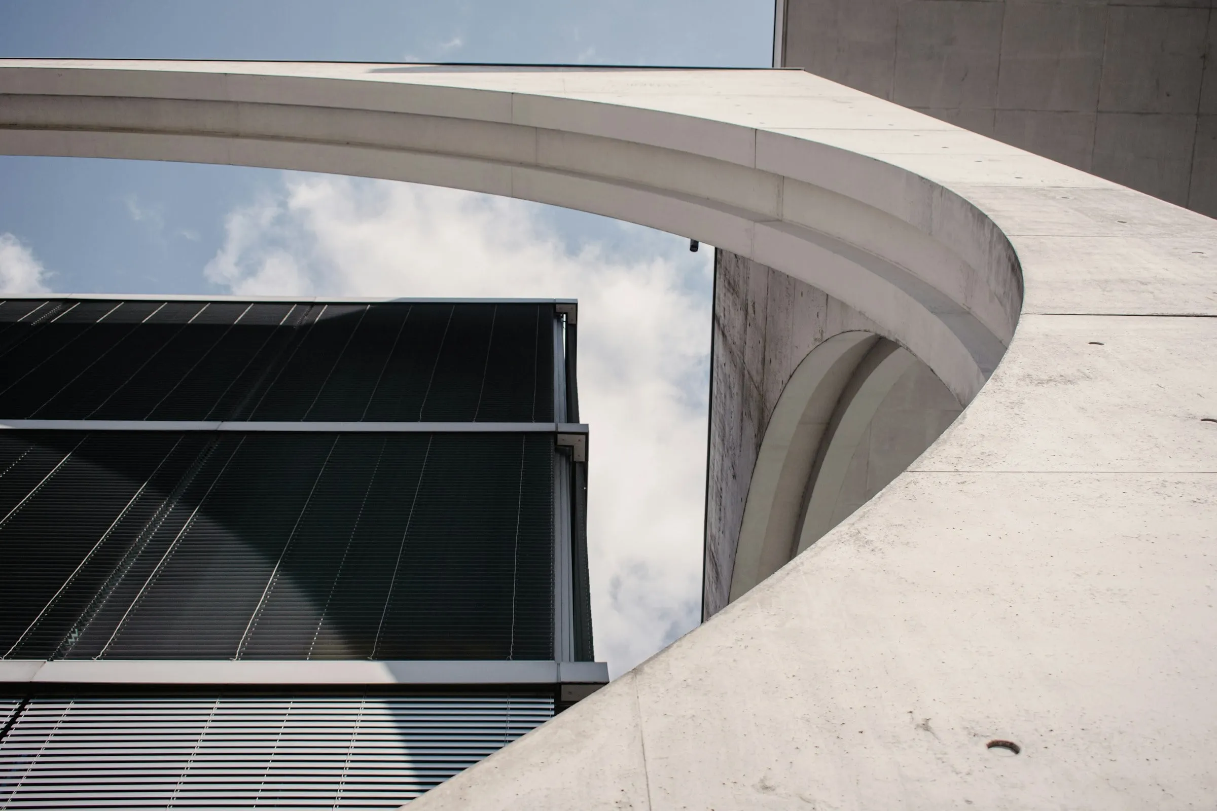 Modern architecture with concrete curves and glass facade